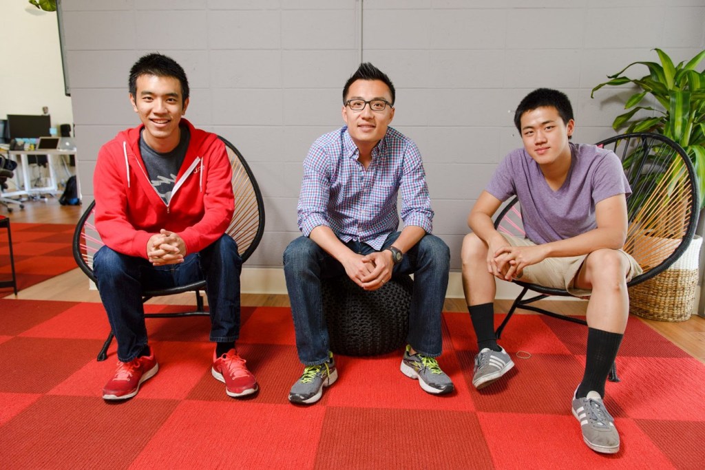 Three men sitting on chairs