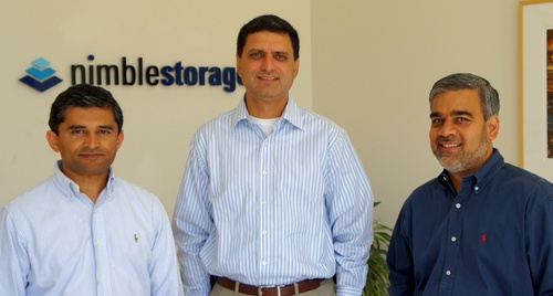 Three men standing in front of a Nimble Storage sign
