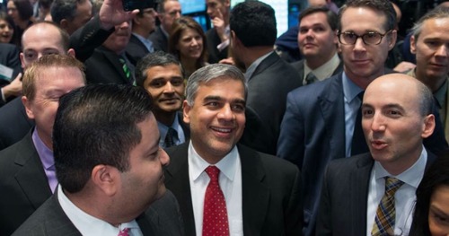 A group of men in suits smiling