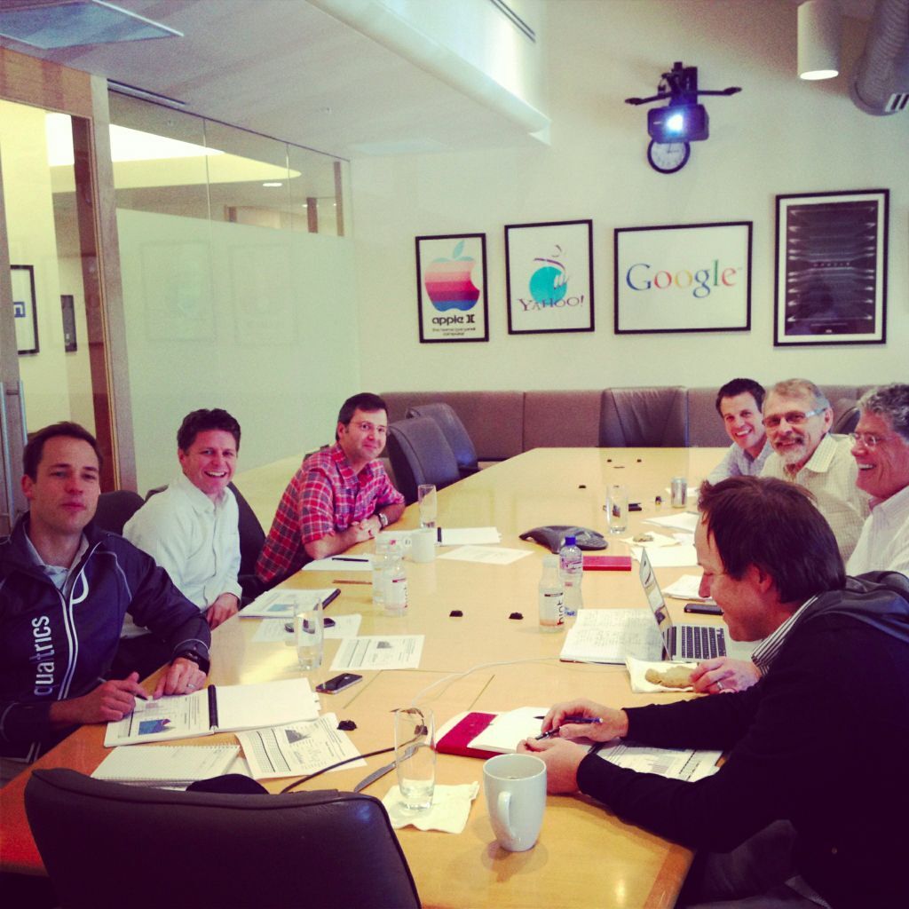 A group of people sit around a conference table